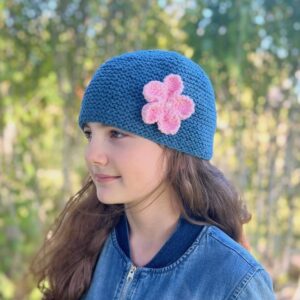 Penelope Garter Stitch Hat knitting pattern #269, blue with pink flower, side