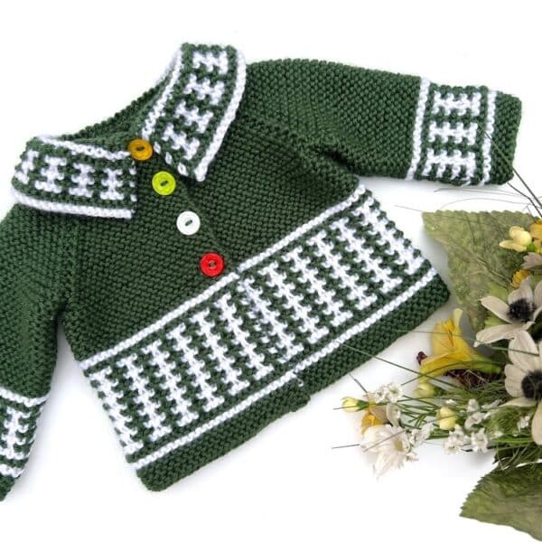 Green and White baby cardigan with colorful buttons.