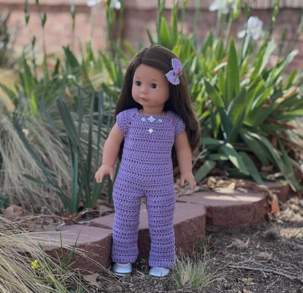 18 inch doll crocheted romper in lavender color decorated with square clear beads on the front .